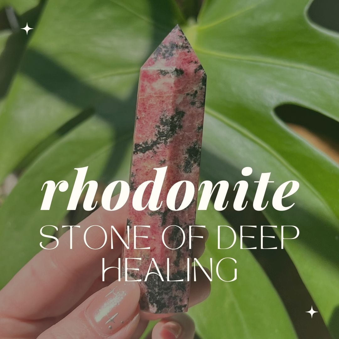 hand holds a pink rhodonite tower in front of a monstera leaf. text reads "Rhodonite: stone of deep healing"