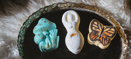 3 beautiful bath bombs spread out on mirrored tray.