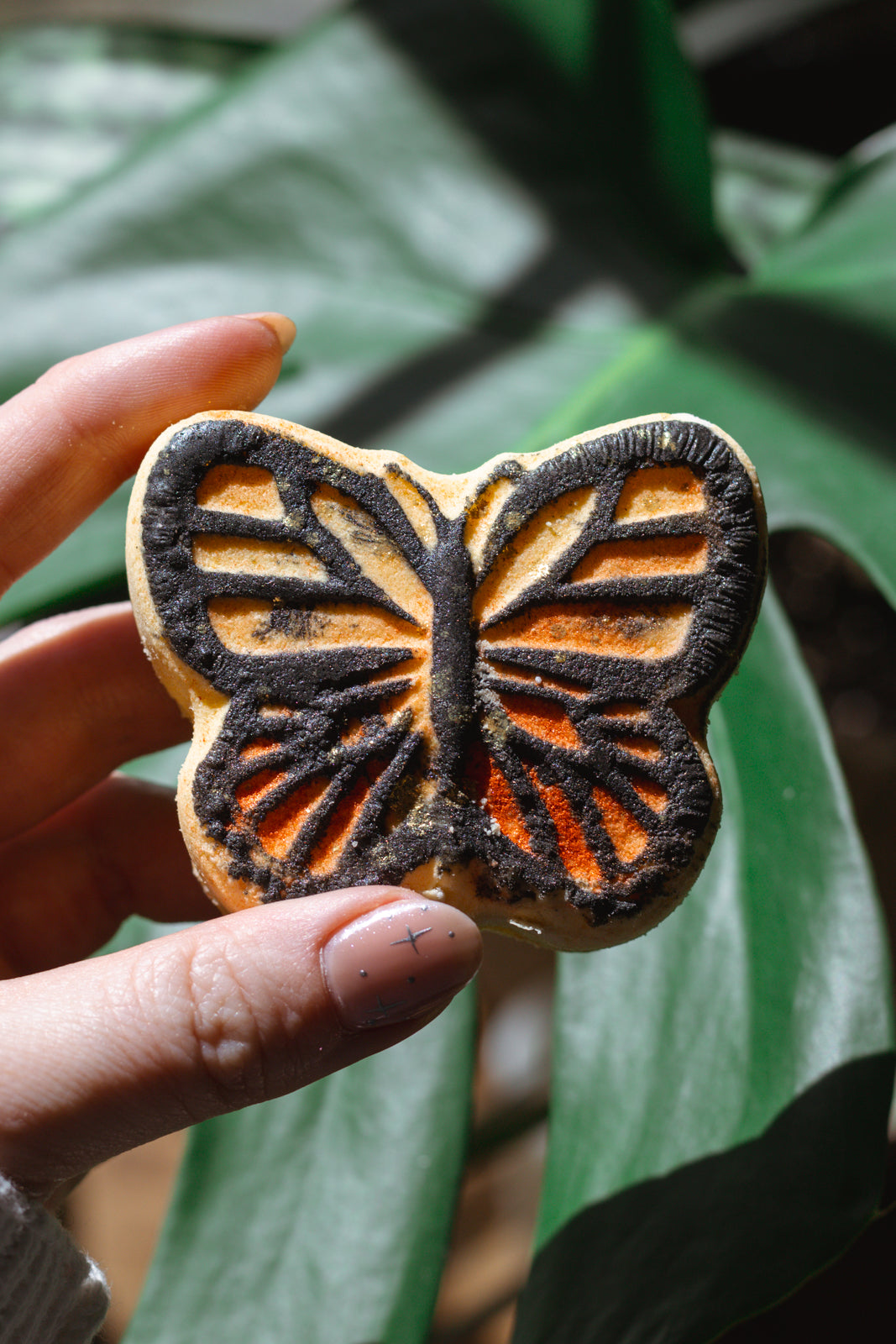 all-natural organic bath bomb painted like a monarch butterfly