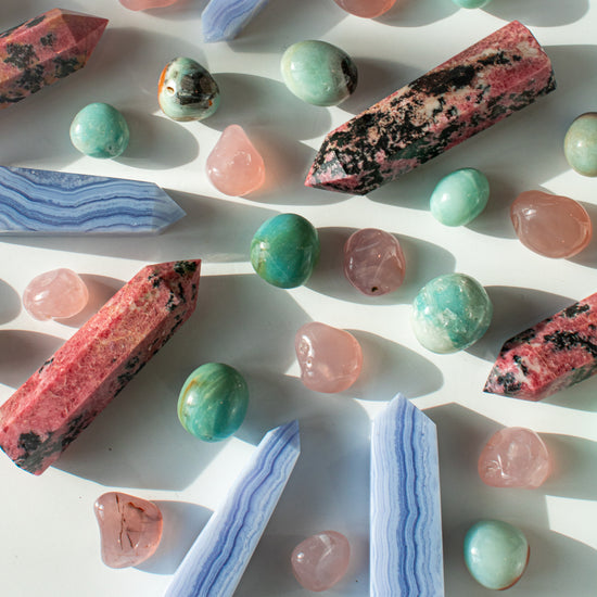 rhodonite points, blue lace agate towers, caribbean calcite stones, and pink chalcedony pocket stones in a gorgeous crystal spread.