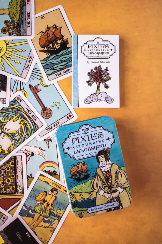 Pixie's Astounding Lenormand cards. This deck features artwork reminiscent of traditional Tarot archetypes, but in a simpler fashion. This 36-card deck comes with a guidebook and symbolic cards like The Bouquet, The Clouds, The Stork, The Stars, and more.
